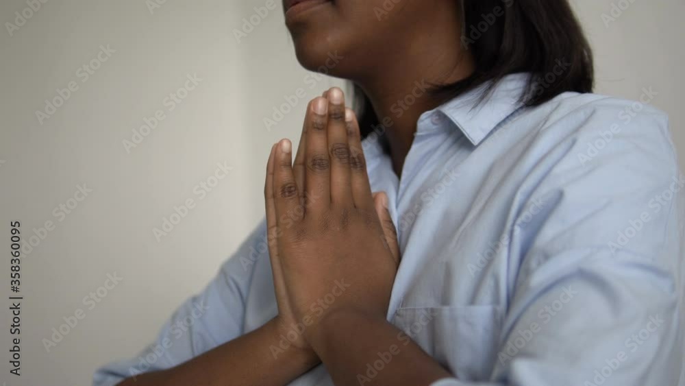 Loving mother clasping hands in prayer for children, love and belief in god Loving mother clasping hands in prayer for children, love and belief in god