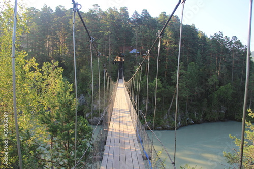 suspension bridge of steel rods on the mountain river