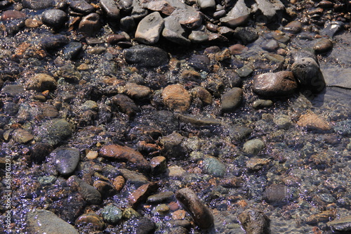 brown stones and clear water as a part of the coast