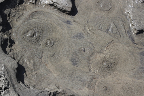 small springs of water hit out of the sand