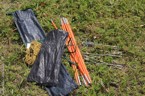 Parts of the tent lie on the grass