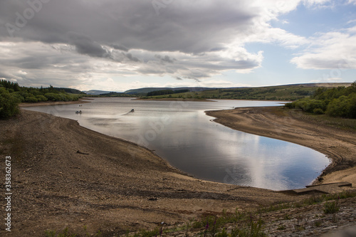 Low water level on a UK reservoir. Fly fishing in drought conditions