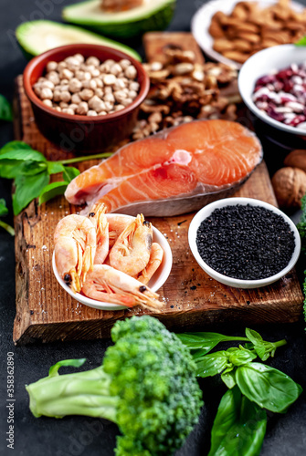 Omega-3 food sources. Foods high in fatty acids  including seafood  vegetables  nuts and seeds on a stone background
