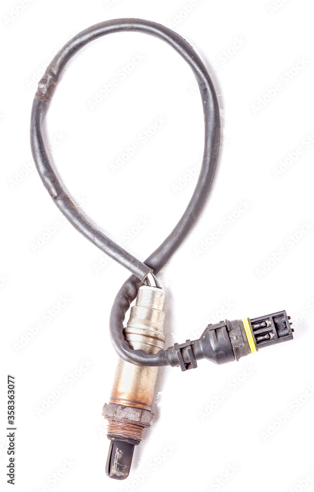 Metal lambda probe is a residual oxygen sensor in the exhaust manifold of an engine on a white isolated background in a photo studio. Spare part for auto diagnostics and repair of car exhaust system. Metal lambda probe is a residual oxygen sensor in the exhaust manifold of an engine on a white isolated background in a photo studio. Spare part for auto diagnostics and repair of car exhaust system.