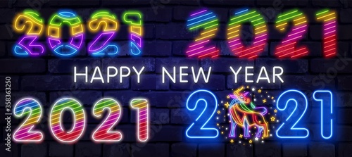 Colorful neon 2021 Happy New Year Neon banner. Realistic bright neon billboard on brick wall. Concept of holiday card with glowing text. 2021 Neon Text.