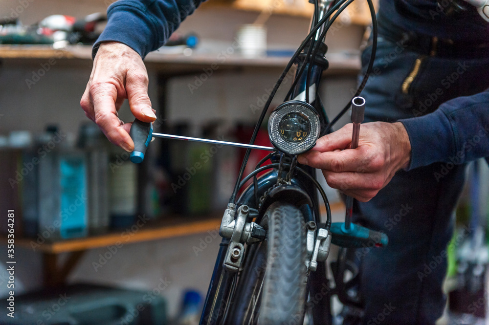 Bicycle mechanic working in bike shop Bicycle mechanic working in bike shop