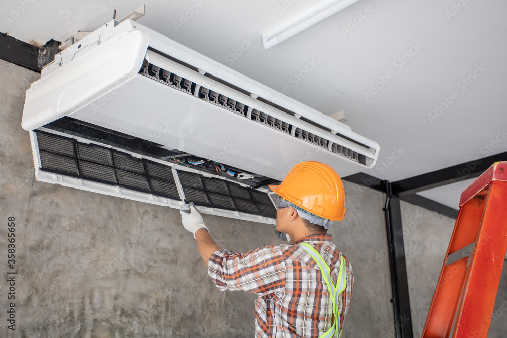 Air Conditioning Technician and A part of preparing to install new air conditioner. Technician vacuum pump evacuates and checking new air conditioner Air Conditioning Technician and A part of preparing to install new air conditioner. Technician vacuum pump evacuates and checking new air conditioner