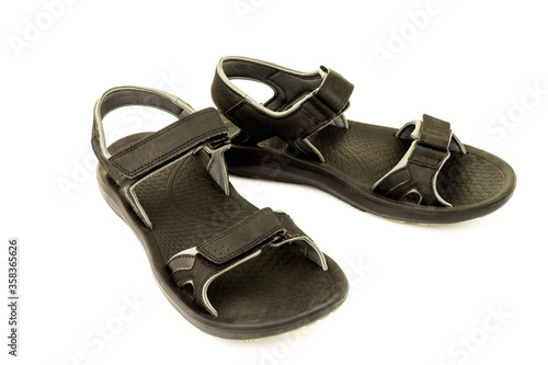 Pair of black leather sandals isolated on white background