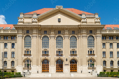 Building of Debrecen University, Hungary. No people. Clear blue sky, summer colors.