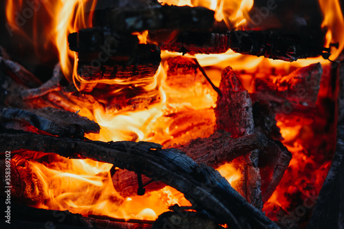 the heat of a fire on the beach by the ocean