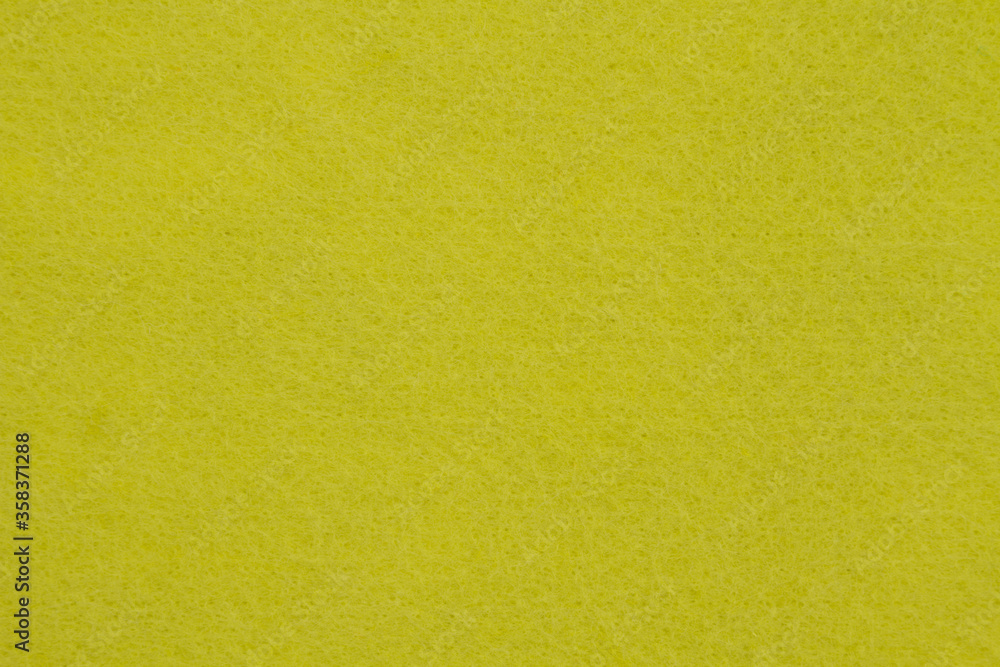 Obraz premium Lemon yellow textured felt fabric material background