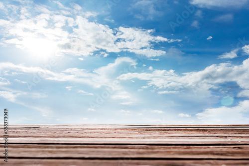 Wood floor with Blue sky of White cloud background