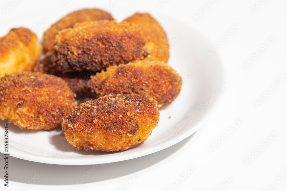 crispy homemade croquettes on a white plate