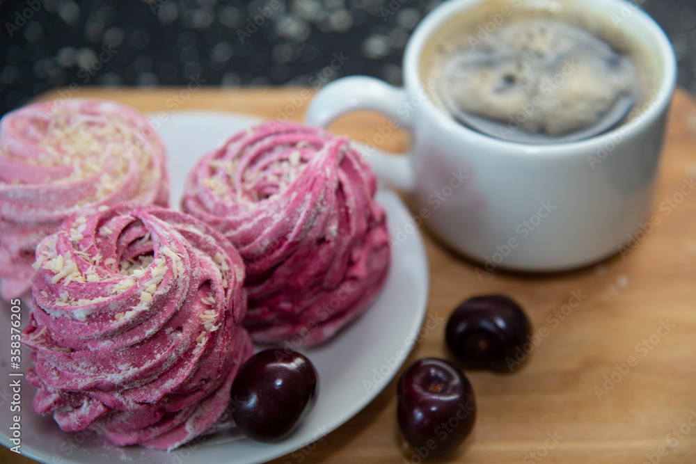 Marsmallows in plate with coffee and cherry. Marsmallows in plate with coffee and cherry.