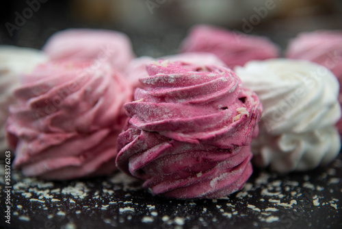Close up of marshmallow cakes of pink, berry and white color.
