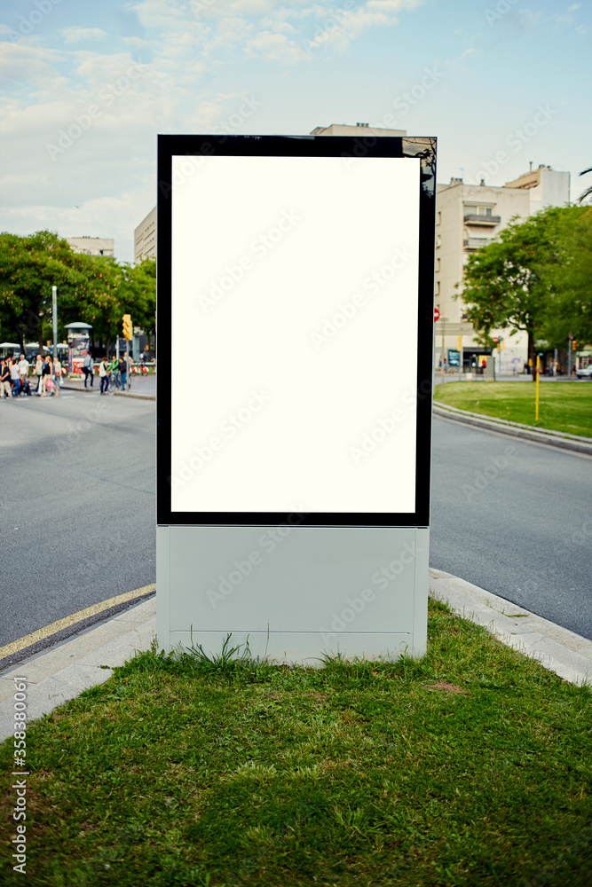 Blank billboard with copy space for your text message or content, public information board on flowerbed with green grass, advertising mock up empty banner in metropolitan city at beautiful sunny day Blank billboard with copy space for your text message or content, public information board on flowerbed with green grass, advertising mock up empty banner in metropolitan city at beautiful sunny day