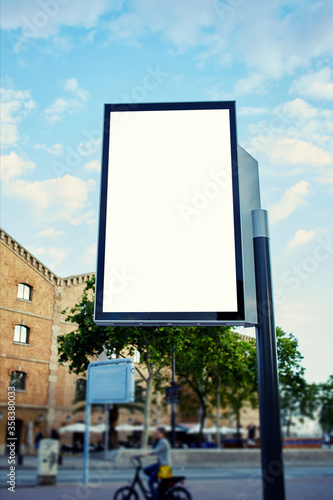 Blank billboard with copy space for your text message or content, public information board in the big town, advertising mock up empty banner in metropolitan city at beautiful sunny day, blur effect