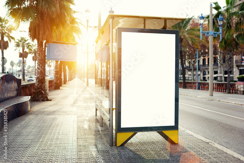 Blank billboard with copy space area for your text message or promotional content, public information board in urban setting, metropolitan city bus stop with empty mock up banner for your advertising