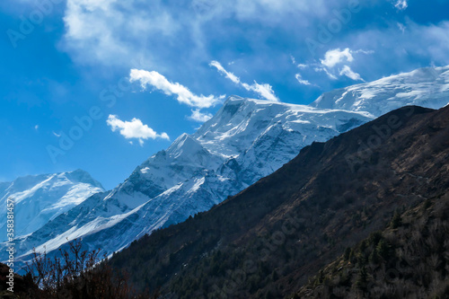 Wallpaper Mural View on high Himalayas along Annapurna Circuit Trek, Nepal. Harsh and barren landscape around. Clear and blue sky. High Himalayan ranges around. Snow capped mountains. Serenity and calmness Torontodigital.ca