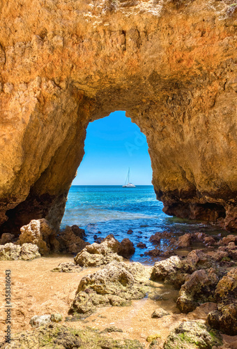 stone arch on the beach, background sea © RAQUEL