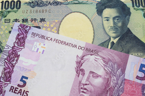 Wallpaper Mural A macro image of a Japanese thousand yen note paired up with a pink and purple five real bank note from Brazil.  Shot close up in macro. Torontodigital.ca