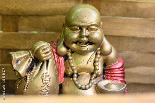 Hotey, laughing Buddha is the god of communication, fun and well-being with a cloth bag of wealth and treasure in his hand.