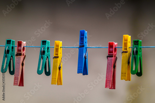 colorful clothespins hanging on a clothesline
