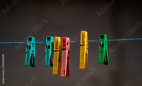 colorful clothespins hanging on a clothesline