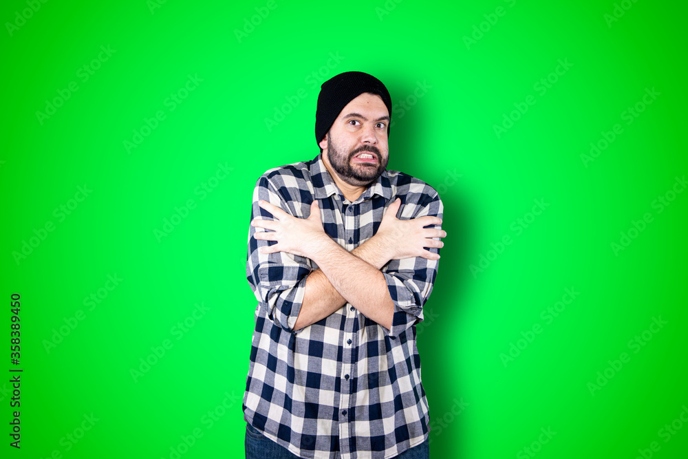 Close up portrait of young bearded male in casual denim outerwear being frozen waiting friend outside in winter. Cold season Close up portrait of young bearded male in casual denim outerwear being frozen waiting friend outside in winter. Cold season