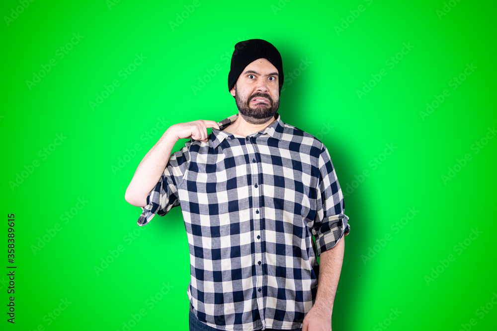 Portrait of relieved good-looking happy male breathing air out and whipping sweat from forehead while smiling broadly and gazing up Portrait of relieved good-looking happy male breathing air out and whipping sweat from forehead while smiling broadly and gazing up