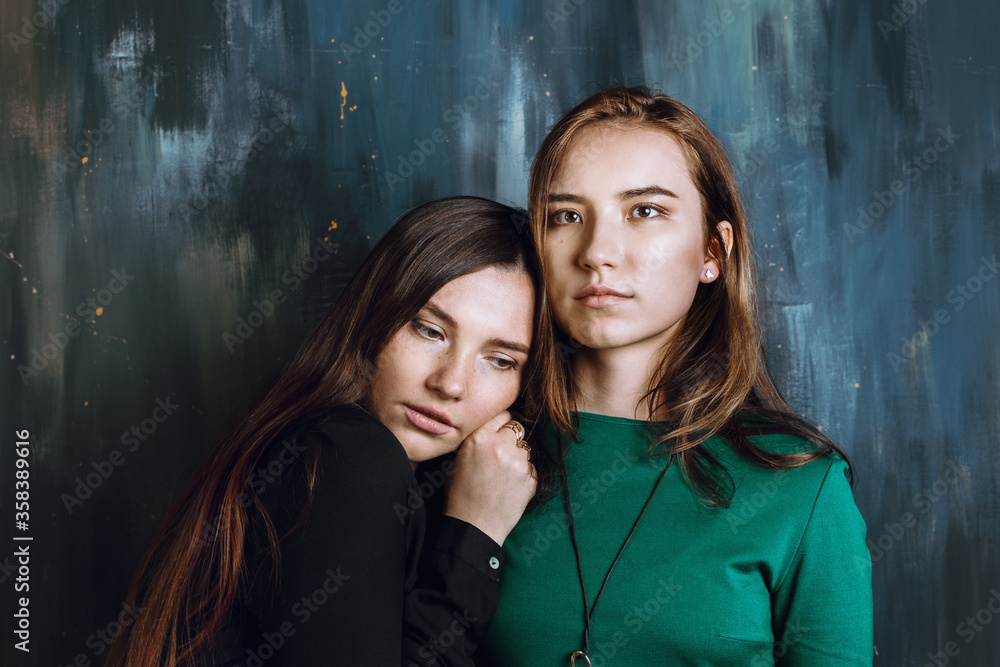 Two young adult sisters or friends hugging Two young adult sisters or friends hugging