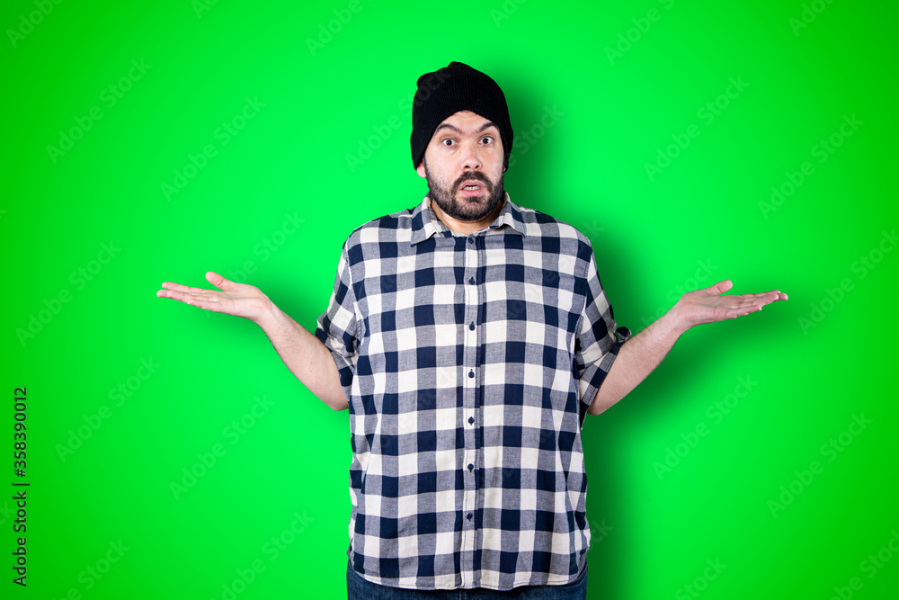 Closeup photo of young handsome man isolated on green studio background dressed casually, looking bored, exhausted and disappointed, feeling helpless and upset facing problems Closeup photo of young handsome man isolated on green studio background dressed casually, looking bored, exhausted and disappointed, feeling helpless and upset facing problems