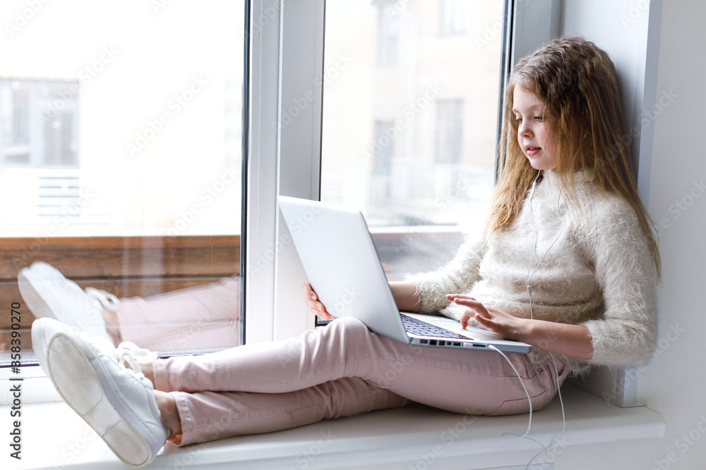 Girl and laptop at home. Child using gadgets to study. Online education and distance learning for kids. Lifestyle Girl and laptop at home. Child using gadgets to study. Online education and distance learning for kids. Lifestyle