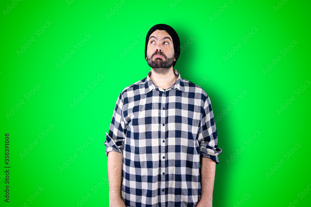 Caucasian handsome man isolated on chroma background thinking an idea while looking up Caucasian handsome man isolated on chroma background thinking an idea while looking up
