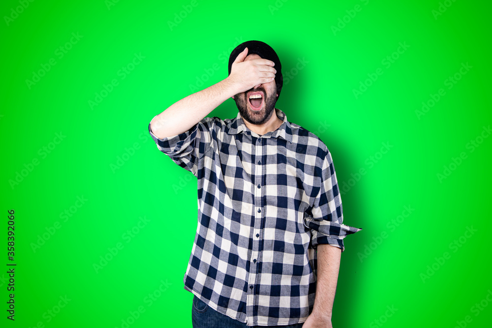 Man over isolated chroma background studio with surprise facial expression Man over isolated chroma background studio with surprise facial expression