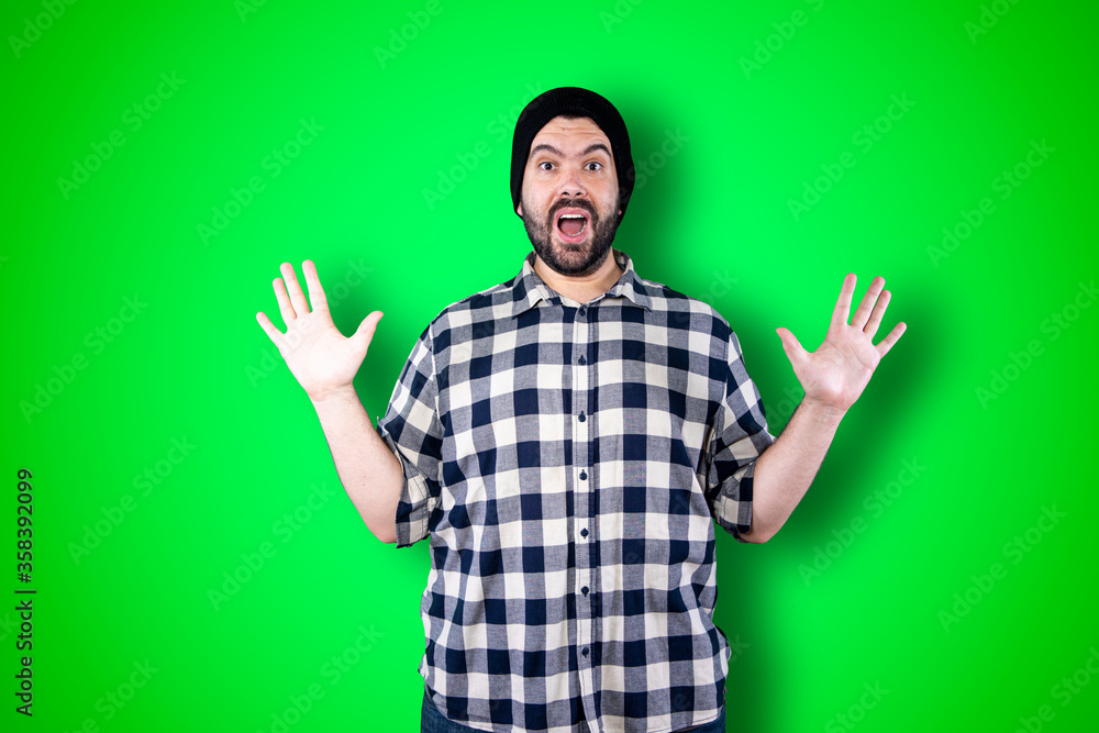 Man over isolated chroma background studio with surprise facial expression Man over isolated chroma background studio with surprise facial expression