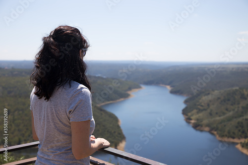 Woman looking at landscape with river © JCDphoto