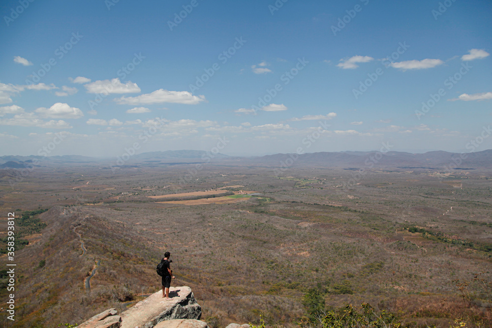 
man on top of the mountain looking at the horizon