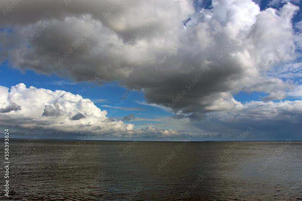 seascape with cumulus clouds beautifully floating above the water surface