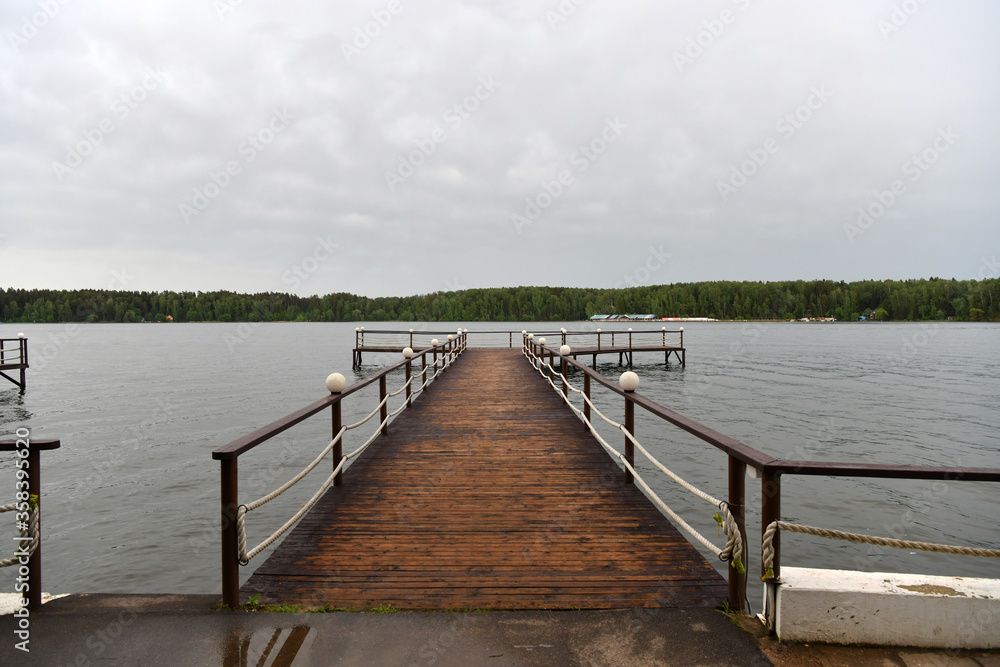 Fototapeta premium landscape with a pier on the river and forest