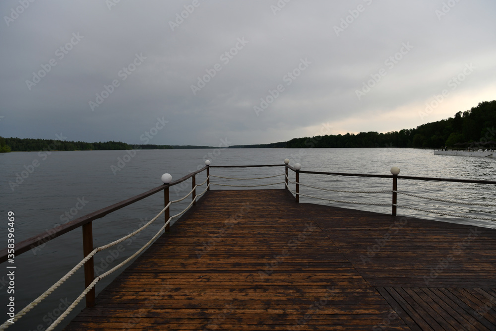 Obraz premium landscape with a pier on the river and forest