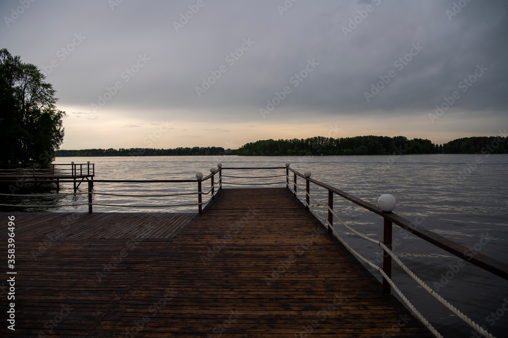 Fototapeta premium landscape with a pier on the river and forest