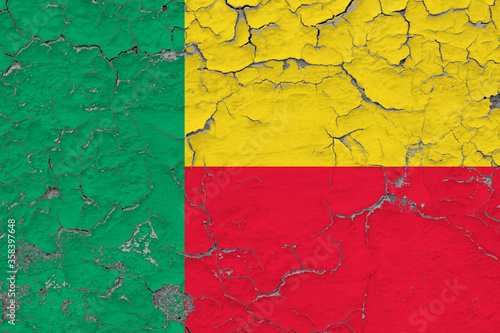 Benin flag close up grungy, damaged and weathered on wall peeling off paint to see inside surface. Vintage concept.