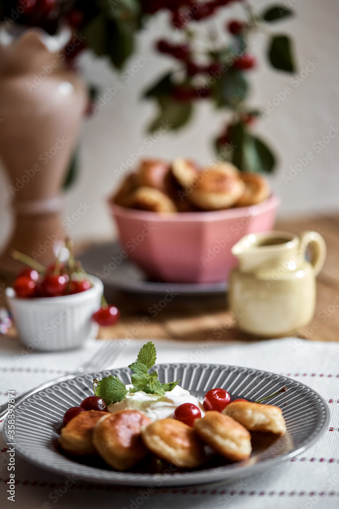 Mini-pancakes, pancakes with cherries and sour cream. Homemade baking. Mini-pancakes, pancakes with cherries and sour cream. Homemade baking.
