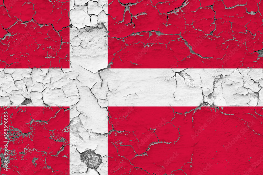 Denmark flag close up grungy, damaged and weathered on wall peeling off paint to see inside surface. Vintage concept.
