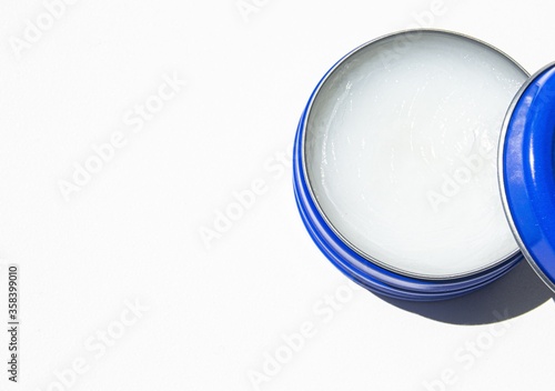 Petroleum jelly in a blue jar for skin moisture and healing. photo