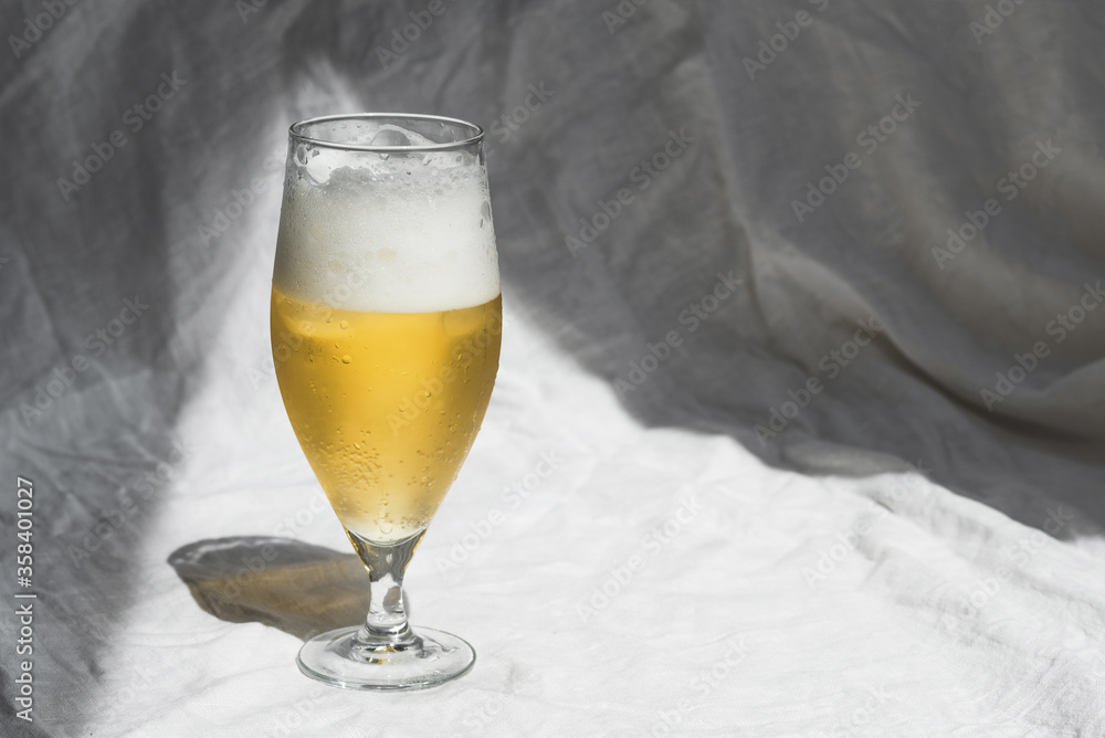 Glass with cold refreshing beer on a white background, in the art style. The concept of relaxation, bars and parties