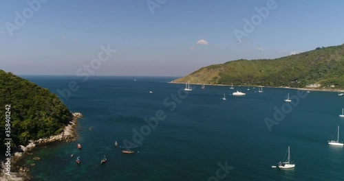 yachts in the bay, boats on the rocky shore, birds fly over the sea, you can see the bay part of the island and the coast