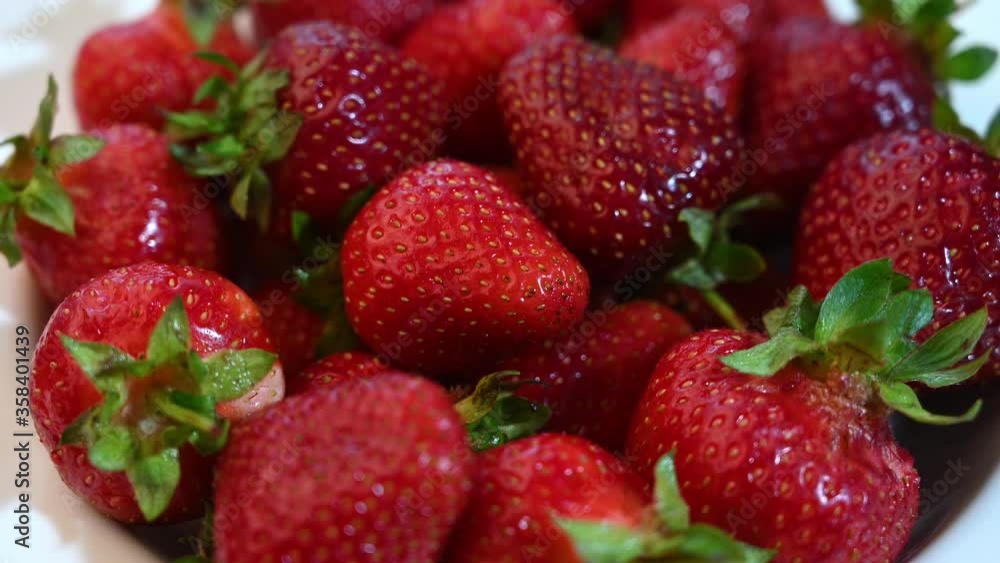 Strawberry berries slow rotate in a plate. Close up. Selective focus Strawberry berries slow rotate in a plate. Close up. Selective focus