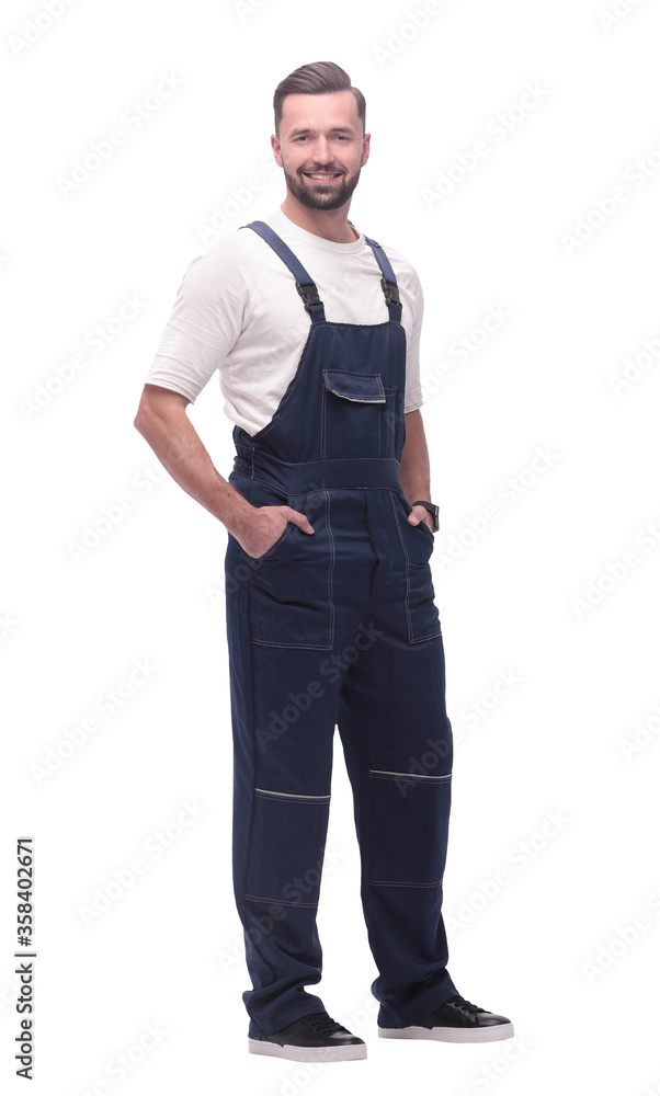 side view. smiling man in overalls looking forward to copy space side view. smiling man in overalls looking forward to copy space